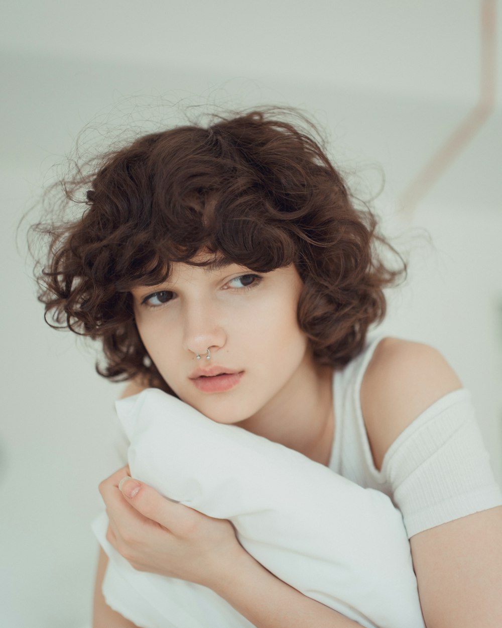 woman hugging white pillow