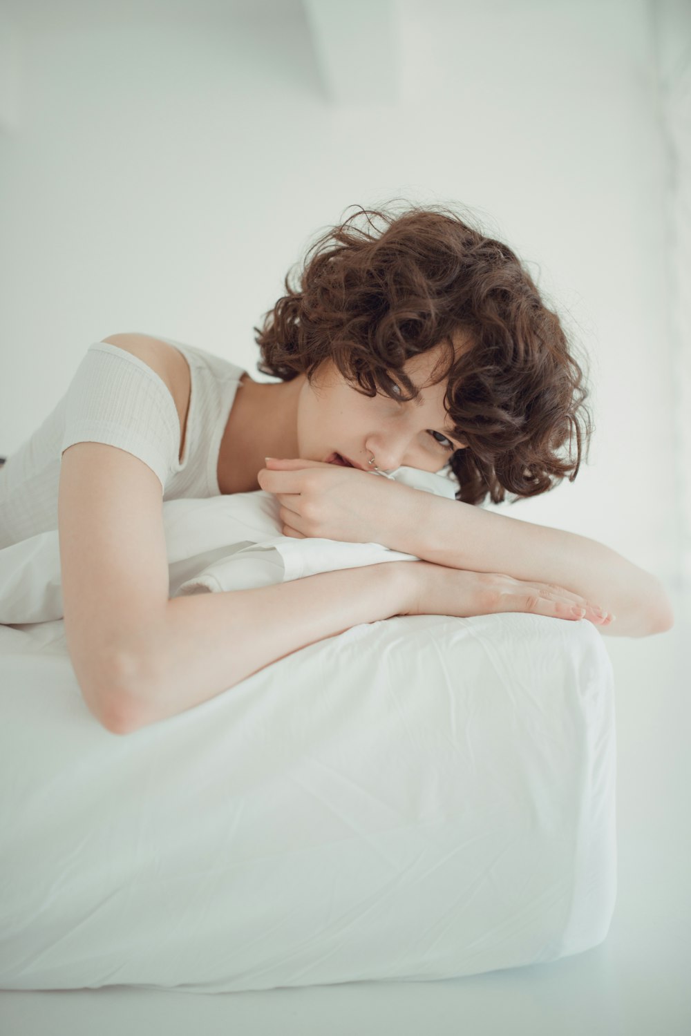 woman laying on white bedding