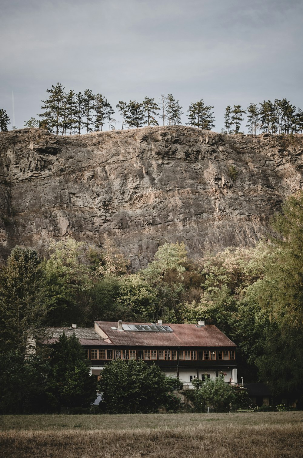 brown and white concrete house beside mountain