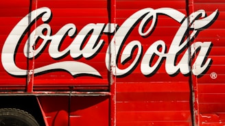 close-up photography of red and white Coca-Cola trailer