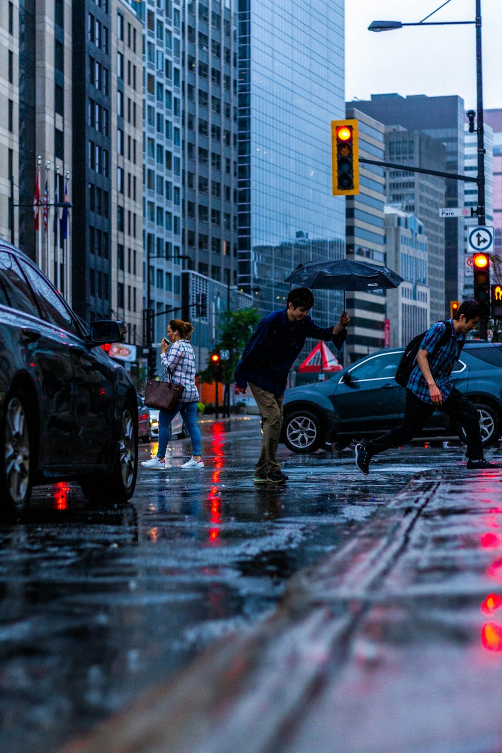 people and vehicle on road near building structures