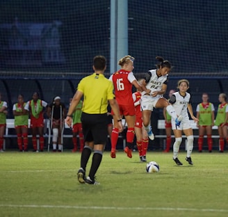 A referee showing a yellow card amidst intense player reactions on the field.