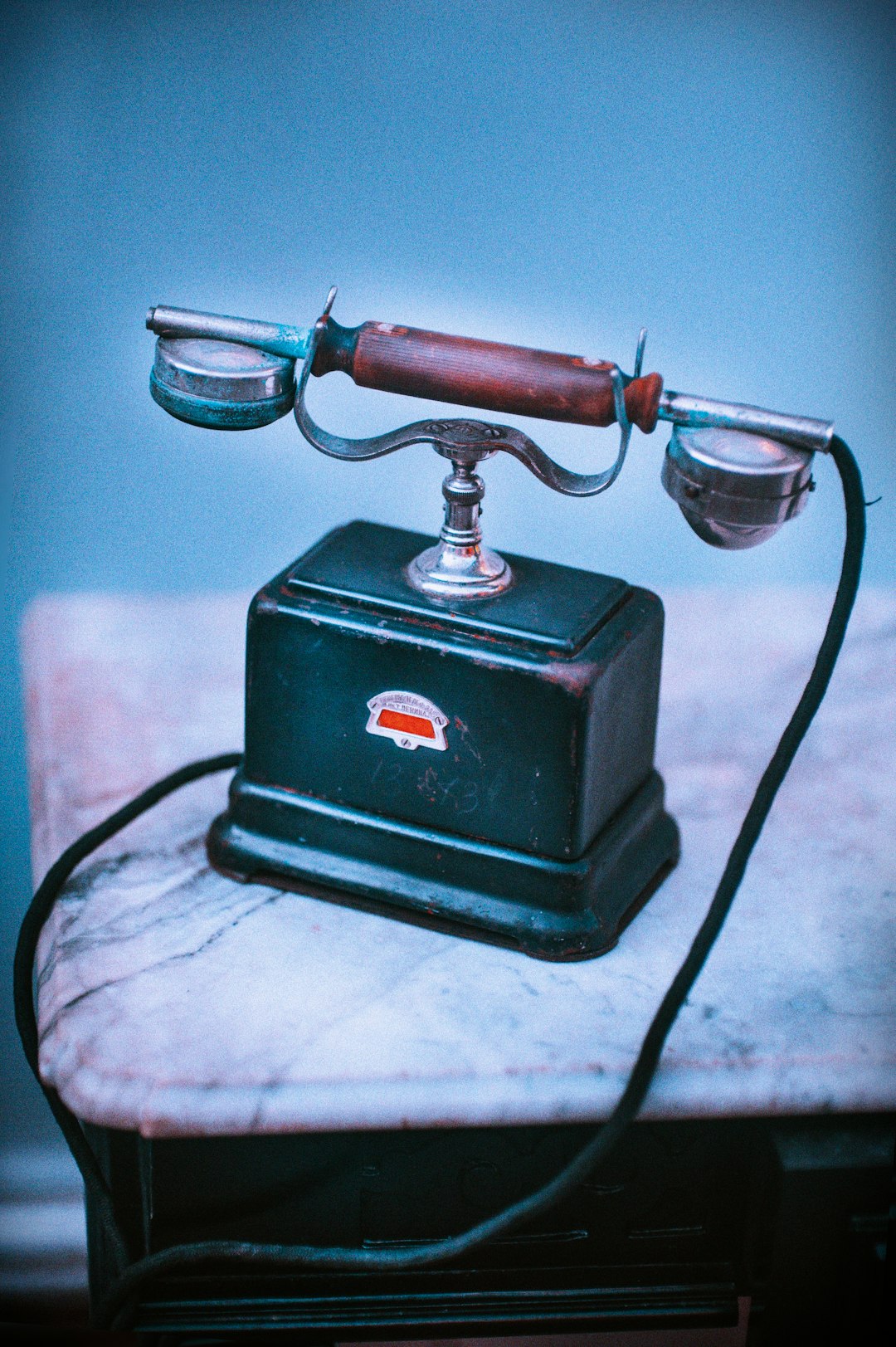 vintage blue and brown telephone on beige surface