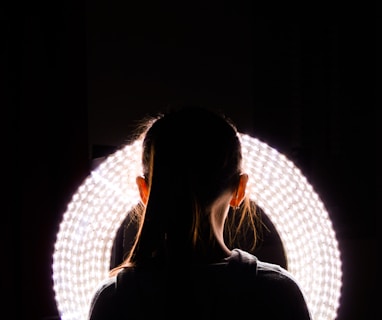 woman standing near round white vanity light