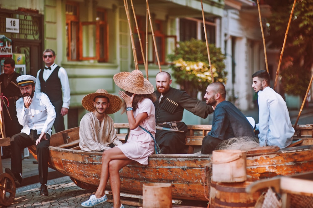 group of people sitting on boat on road