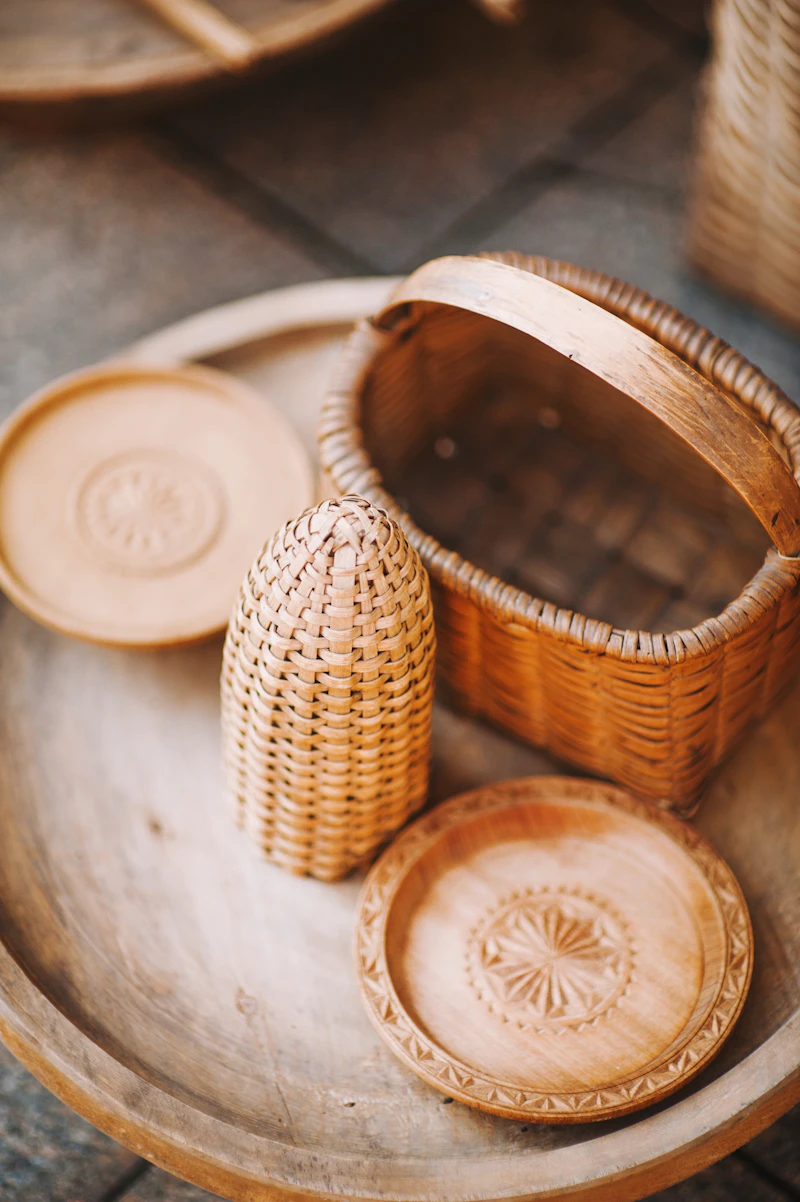 A brown wicker basket on a round tray