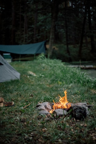 fire pit near gray dome tent at daytime