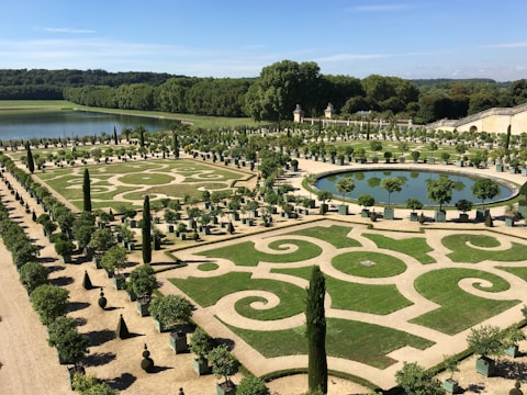 A formal garden with neatly trimmed hedges and pathways.