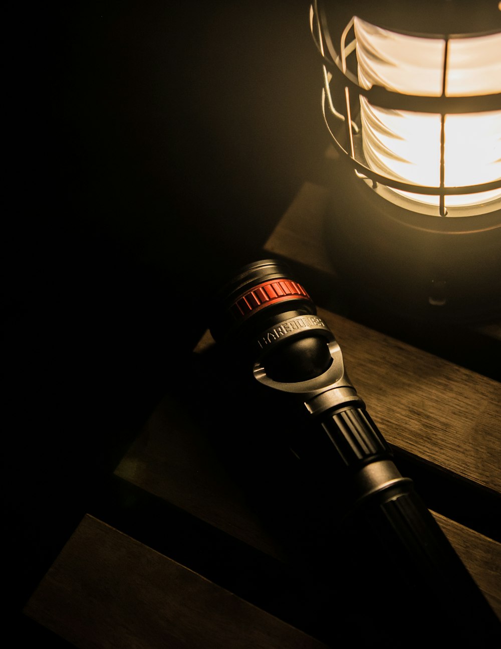 black flashlight beside lantern