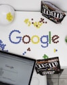 photo of M&M forming Google chocolate candies on table