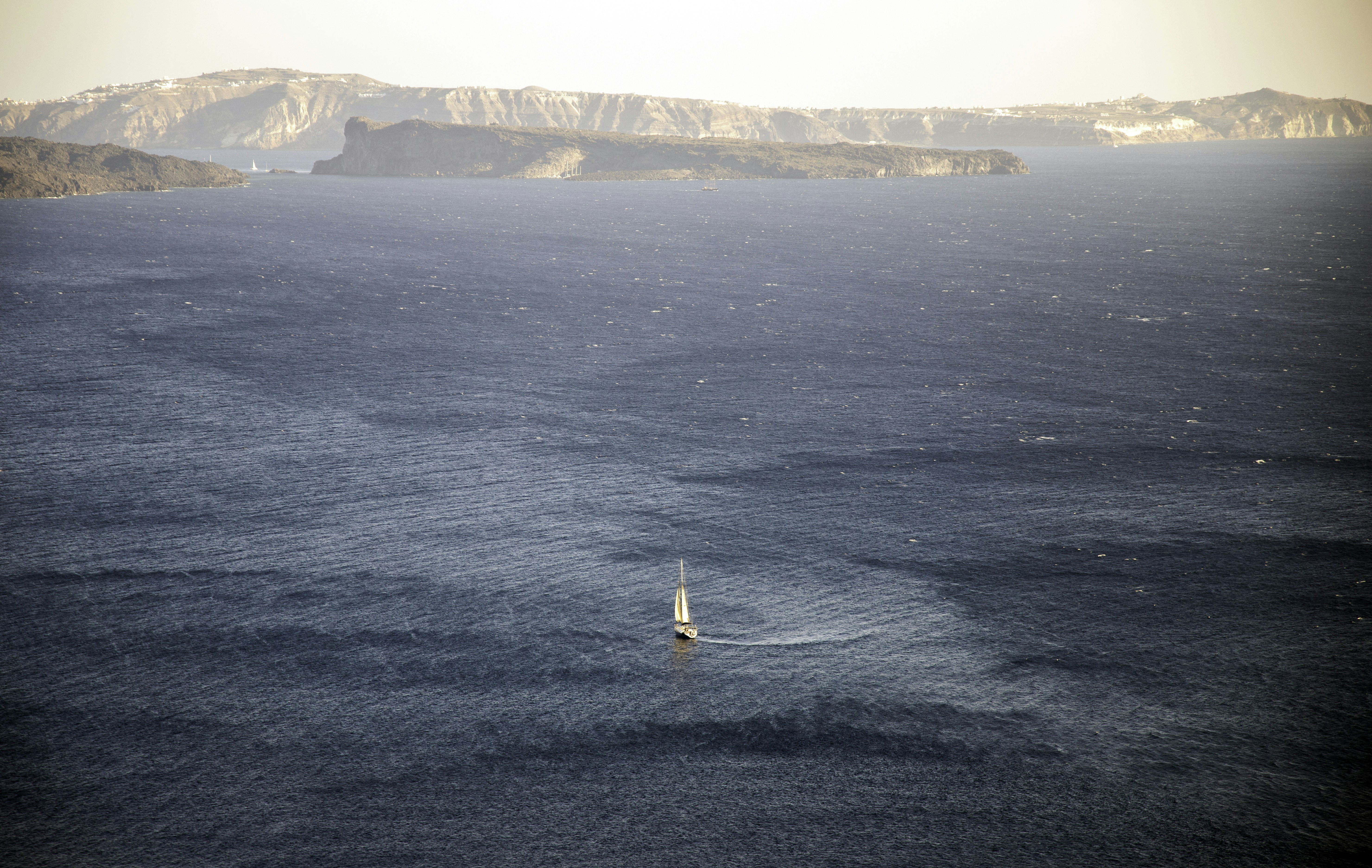 sailboat on ocean during daytime, Sailboat making a turn on open sea