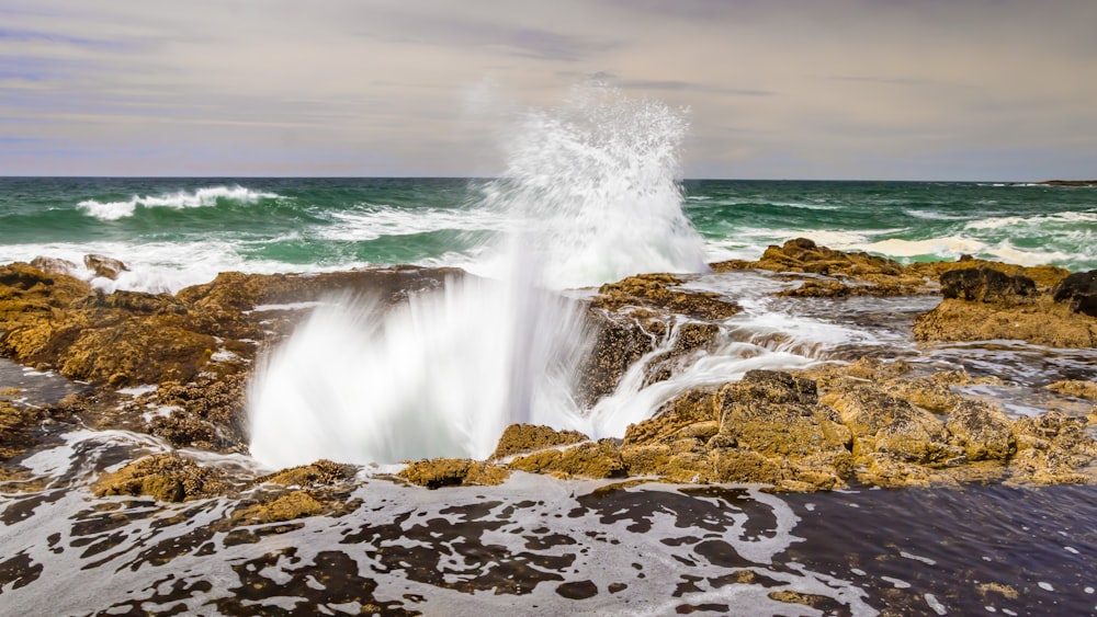 rock formation near body of water during daytime