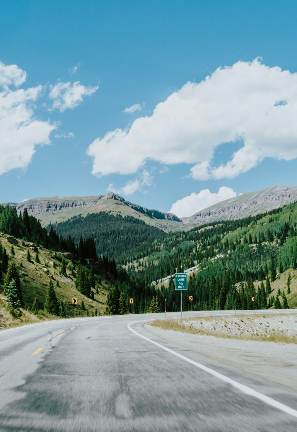 road with street sign overlooking mountain