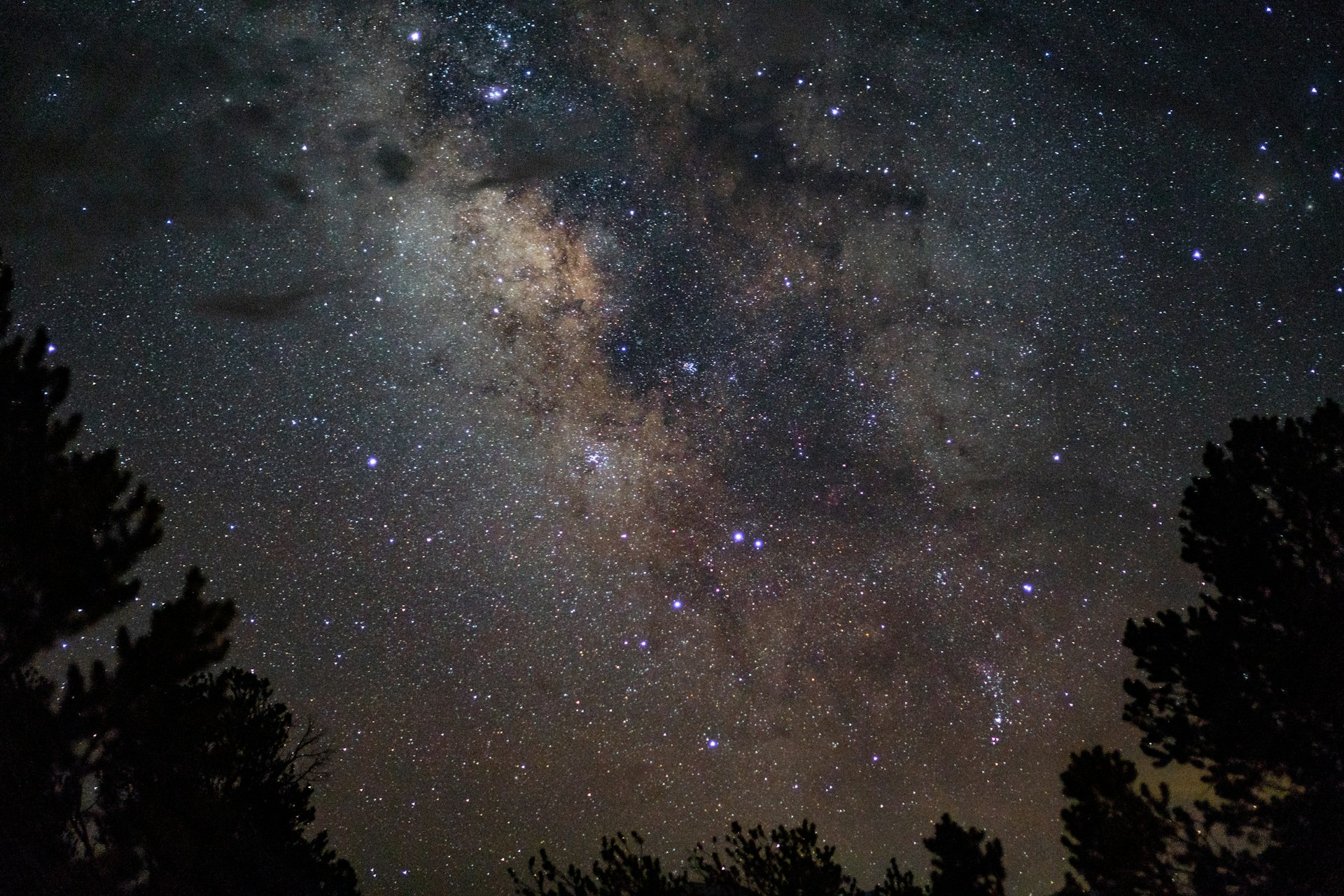 A peaceful view of a distant galaxy with glowing clusters of stars, symbolizing expansive growth and inner transformation.