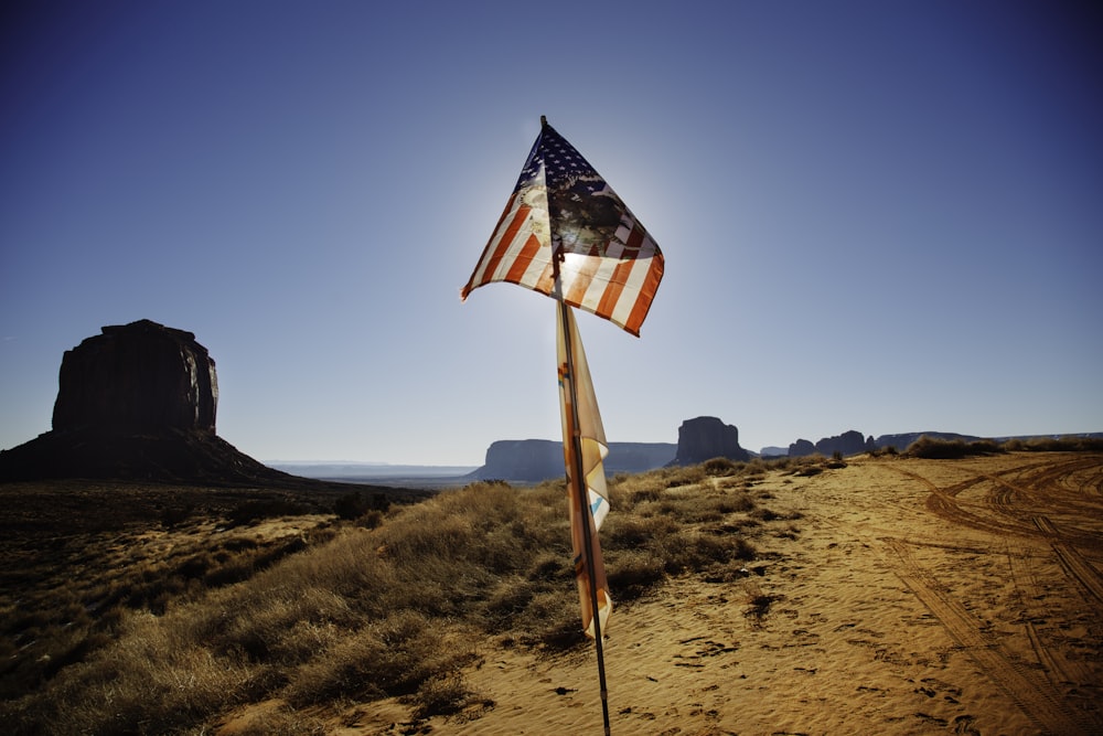 USA flag waving over brown sand