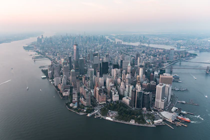 Dense waterfront city seen from the air at dusk