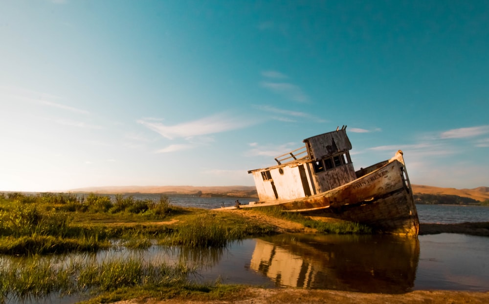 abandoned boat on body of water