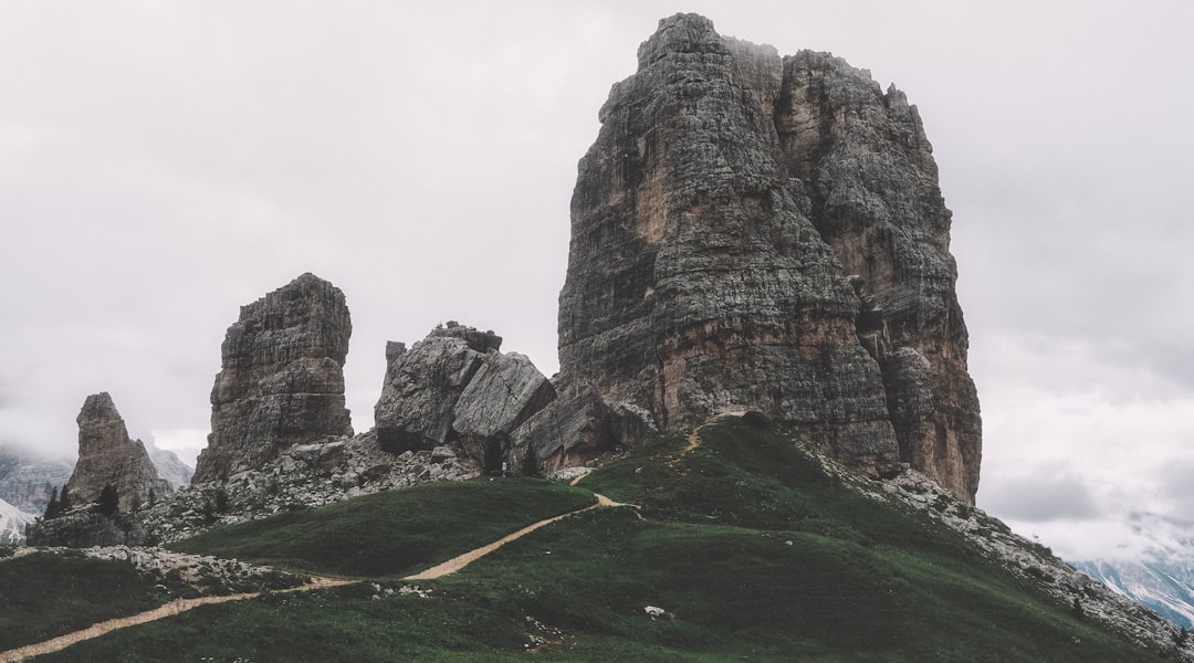 rock formation under cumulus clouds