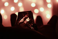 Close-up of hands holding a glowing amethyst crystal symbolizing inner healing.