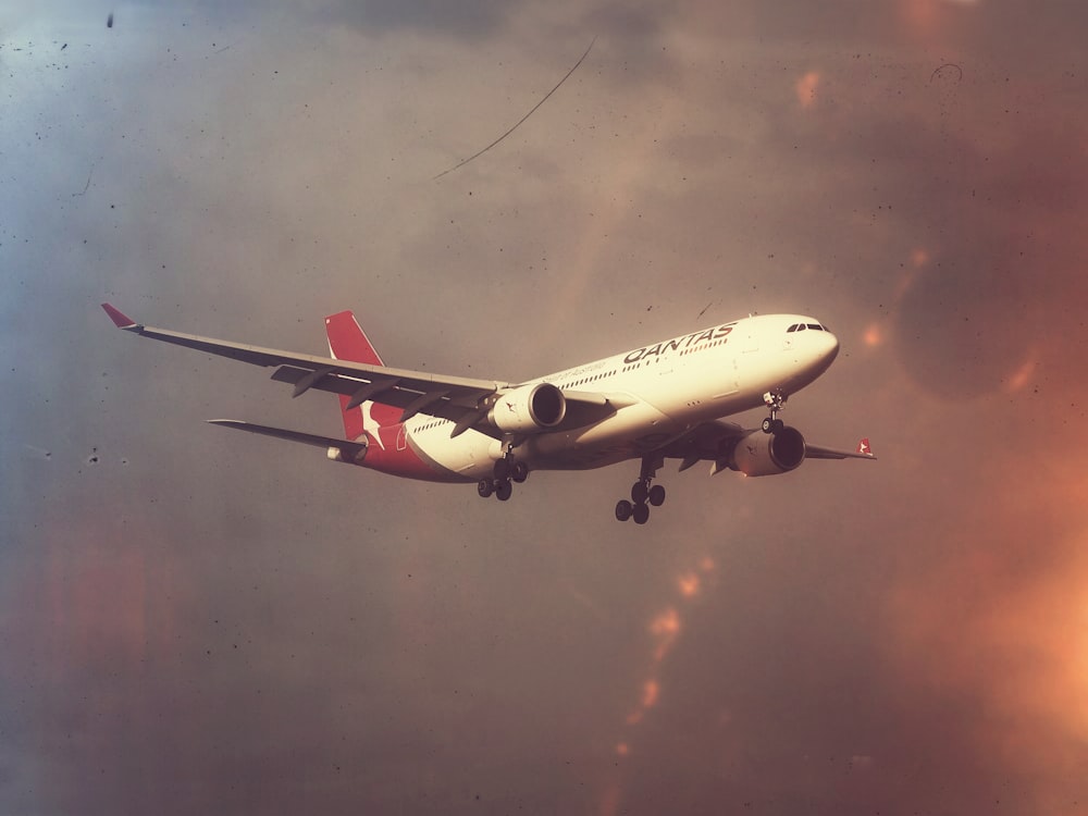 white and red airplane in flight