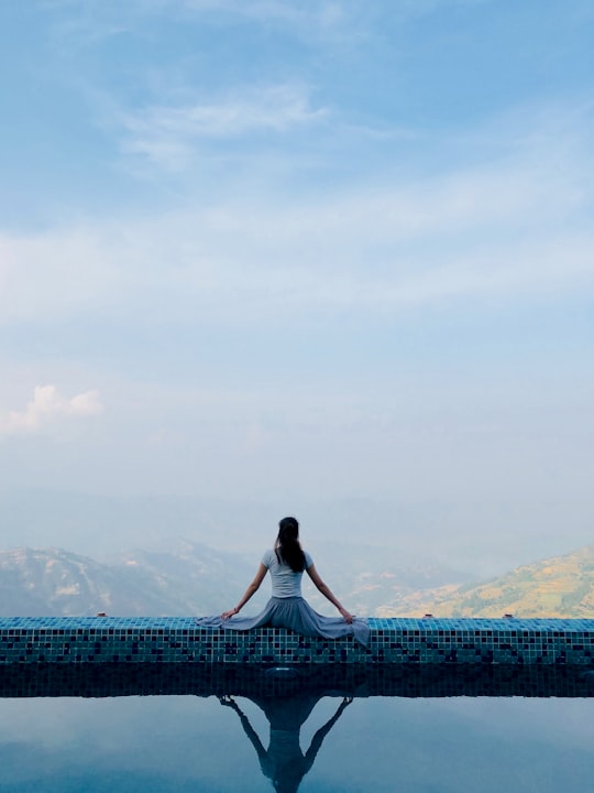 woman sitting on pool gutter in Kathmandu Nepal