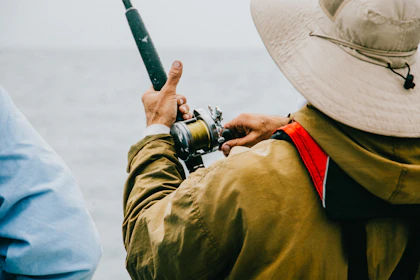 person holding black fishing rod