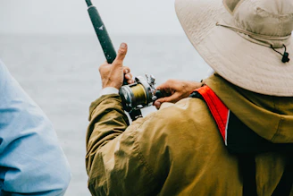 person holding black fishing rod