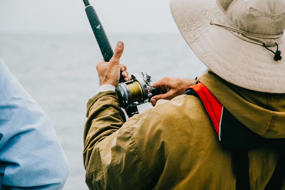 person holding black fishing rod