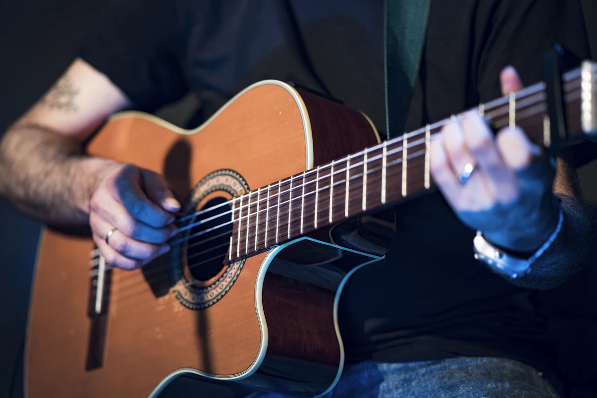A hollow-body guitar played in a dim club