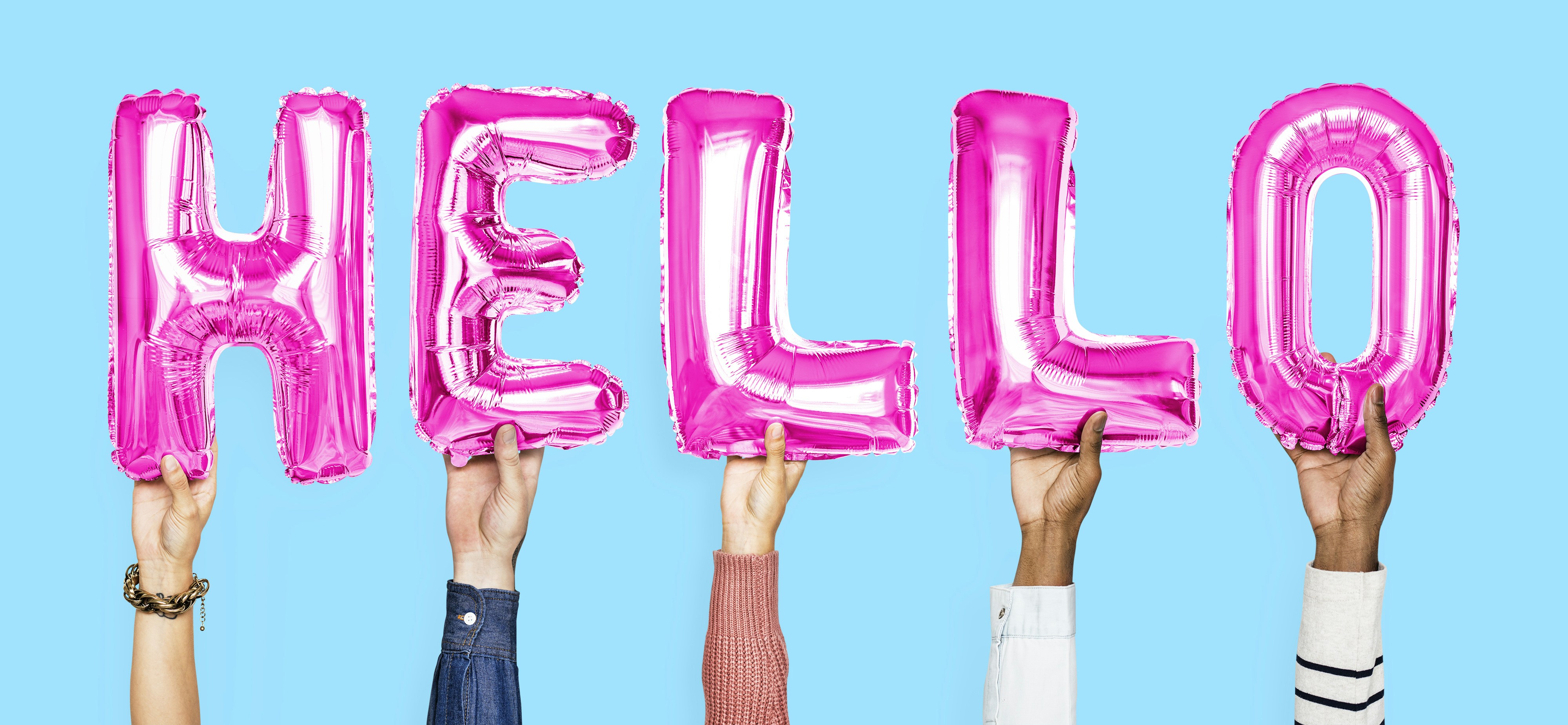 person holding hello decor