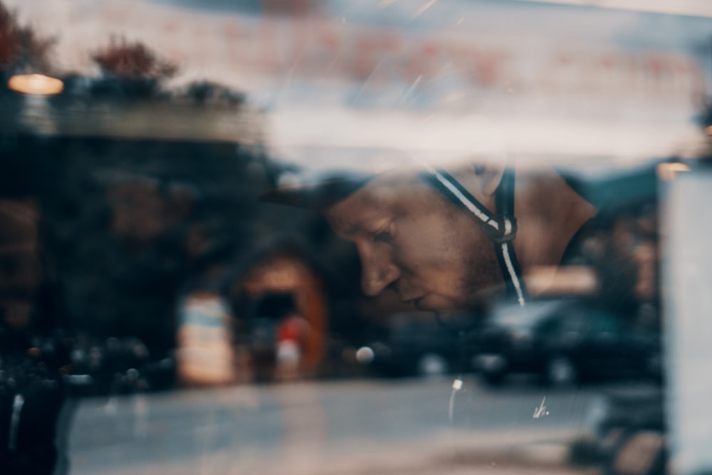 a reflection of a man in a store window