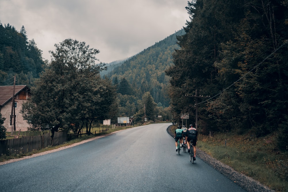 three person riding on a bicycles during daytime