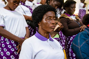 woman wearing white polo shirt closing eyes