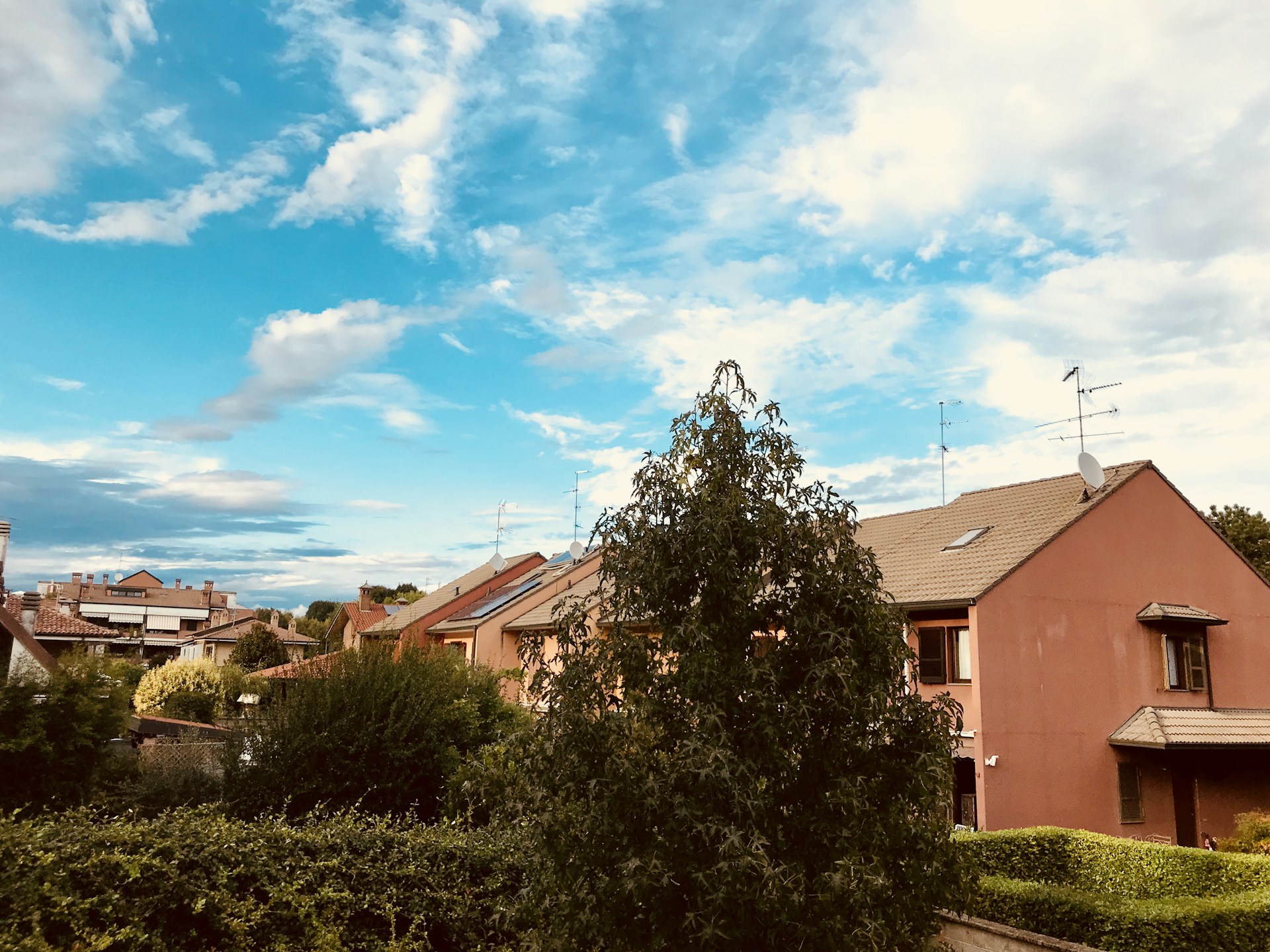woman wearing yellow long-sleeved dress under white clouds and blue sky during daytime