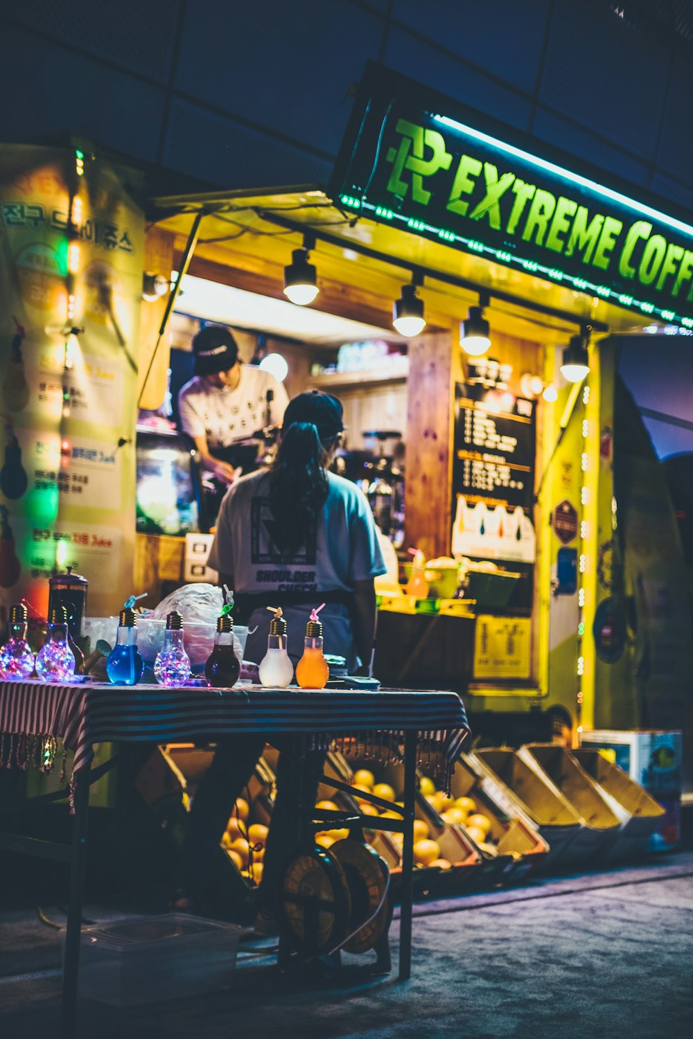 woman standing in front of Extreme Coffee store facade