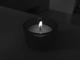 A calming scene of a candle flickering beside a cup of tea on a light ivory desk.