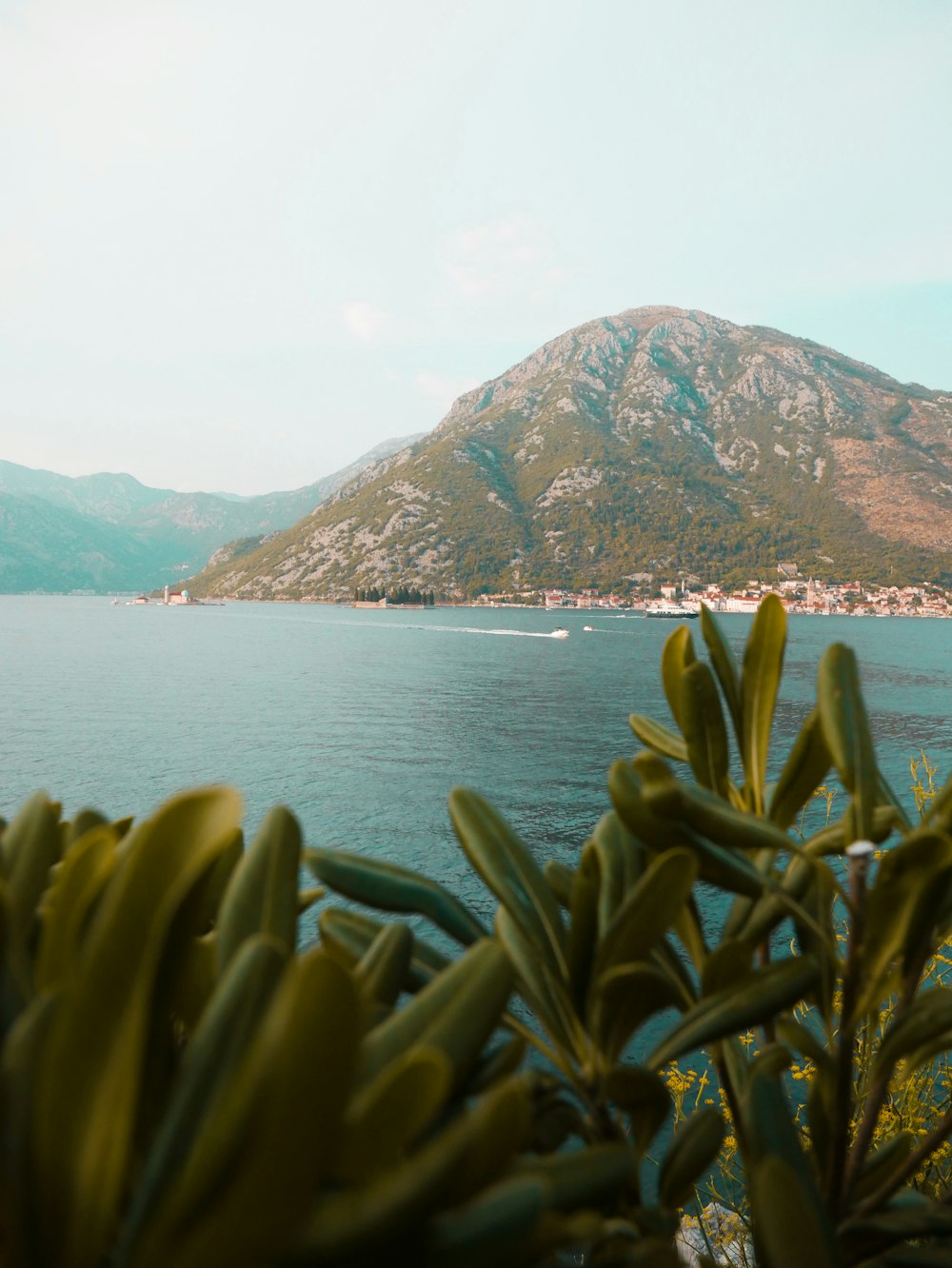 mountain near body of water under blue sky at daytime