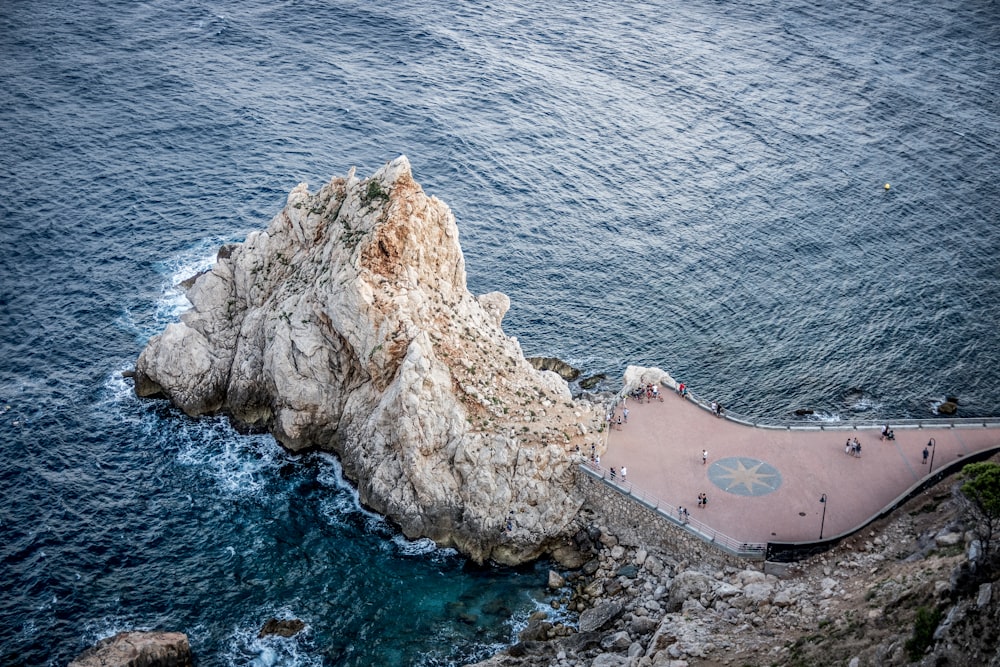 aerial photography of cliff on body of water