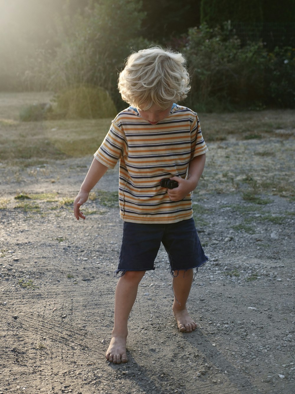 boy wearing brown and black striped t-shirt