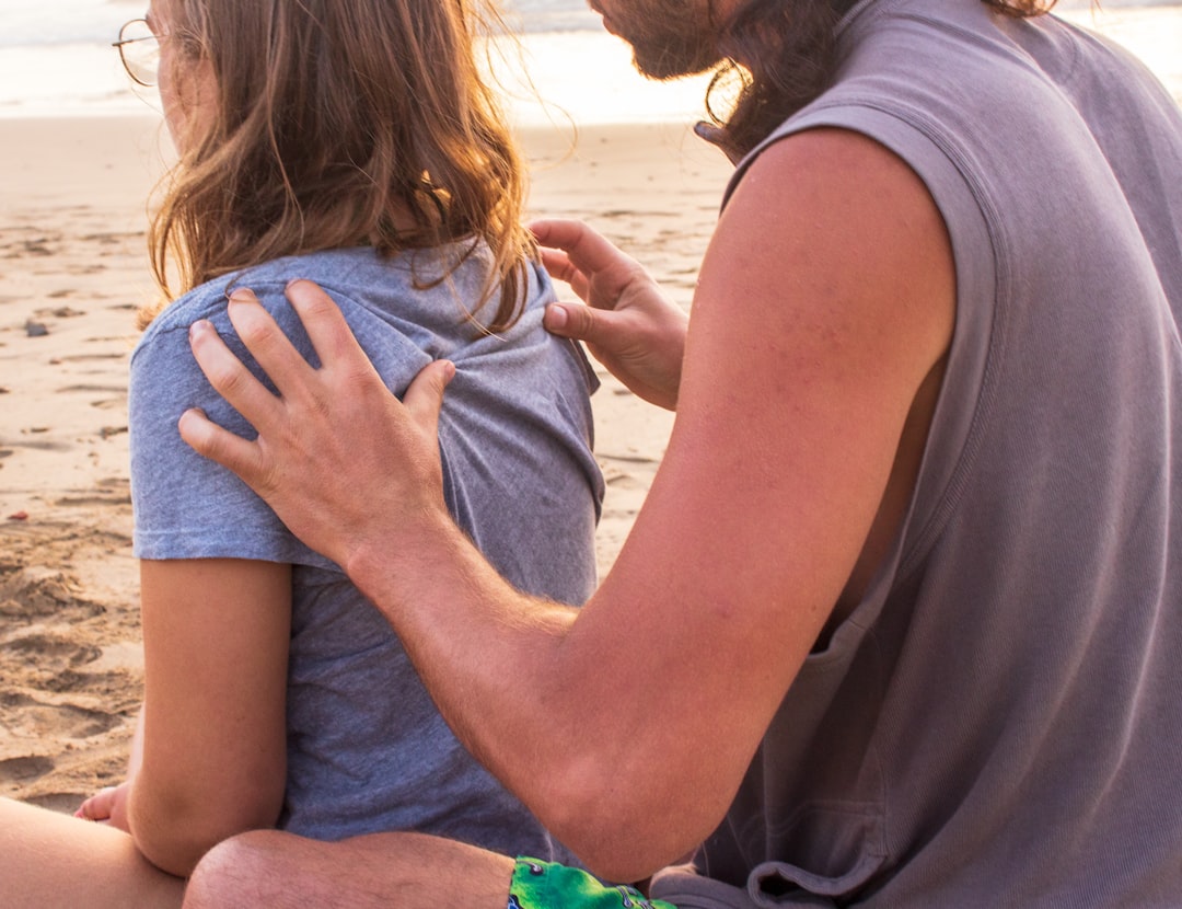 adult child comforting parent hand on shoulder support