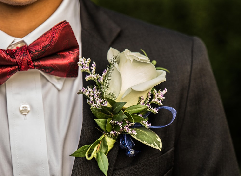 white rose on man's suit jacket