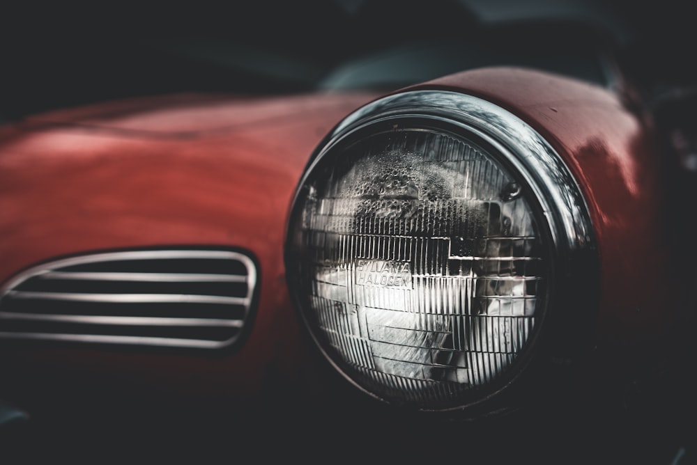 selective focus photography of red car headlight