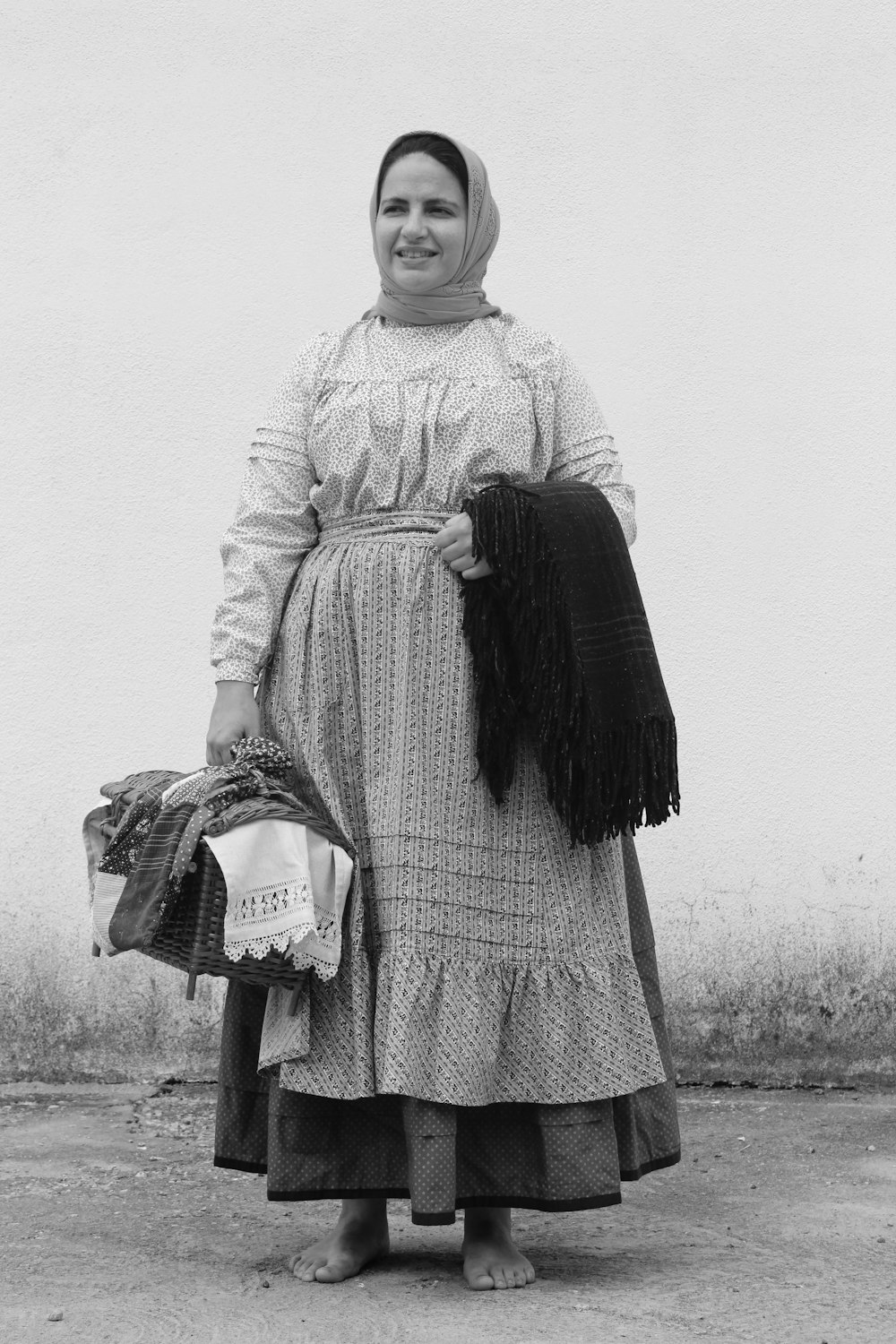grayscale photo of woman holding handbag and scarf