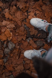 high-angle photography of person wearing white sneakers