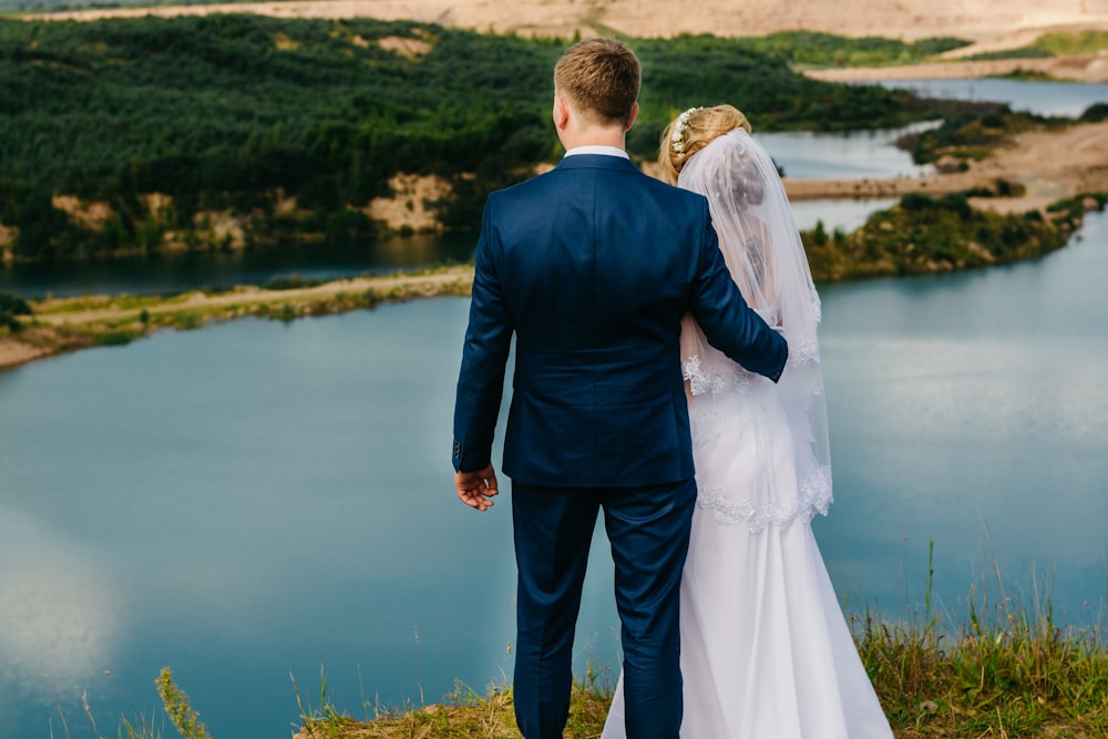 groom and bride standing on a cliff
