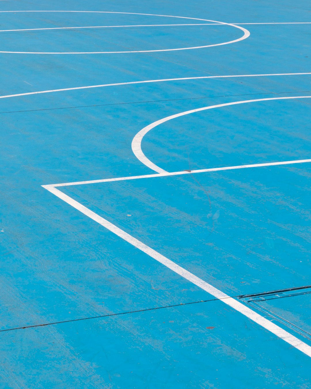 white line on blue basketball floor