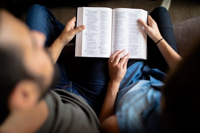 couple reading book on couch