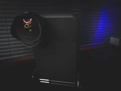 Artistic shot of a hongrui projector light’s lens reflecting soft, colorful light patterns.