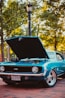 teal Chevrolet SS coupe parked near lamp post