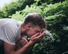 man washing his face